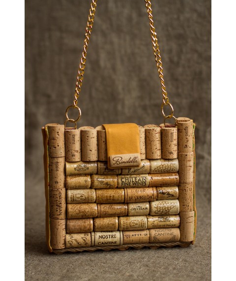 Wine cork clutch with a chain over the shoulders.