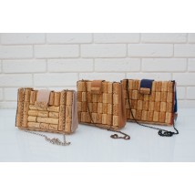 Wine cork clutch with chain over the shoulder.