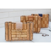 Wine cork clutch with a chain over the shoulders.