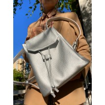 Backpack female urban medium with a flap with a tightening on a button lightweight soft eco-leather silver gray