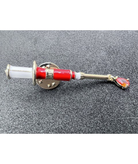 Medical jewelry (syringe) red enamel with zirconium.